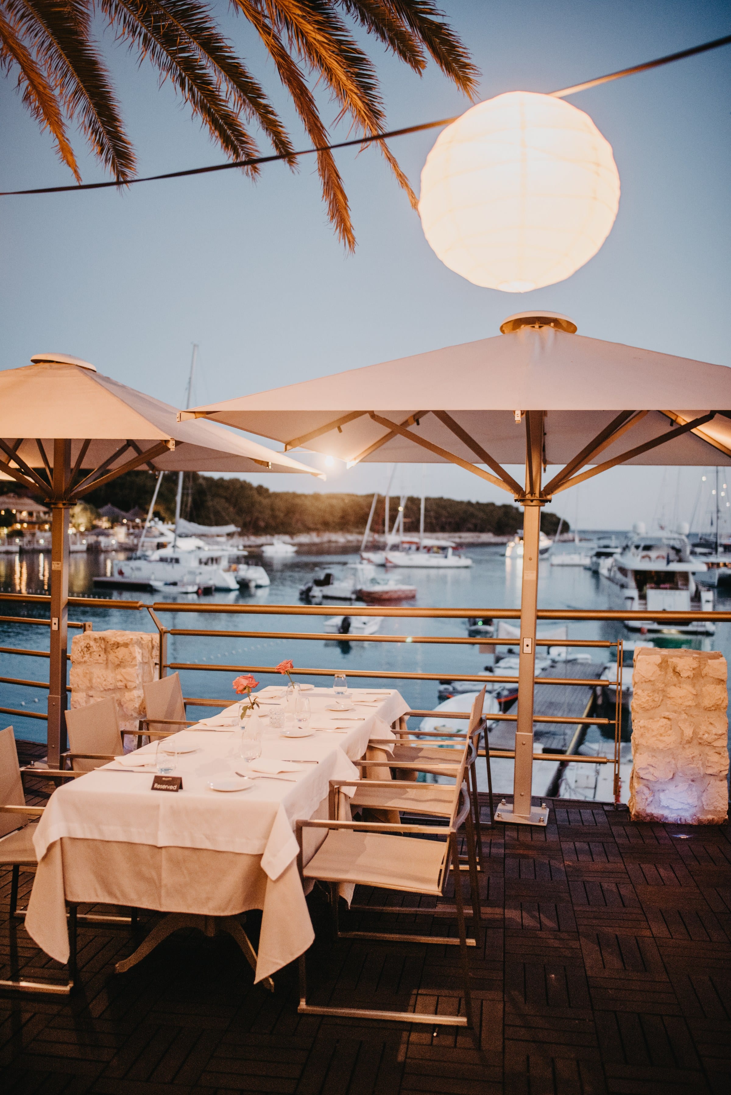 Evening at the Zori restaurant on Palmižana, candlelit tables along the Adriatic shore