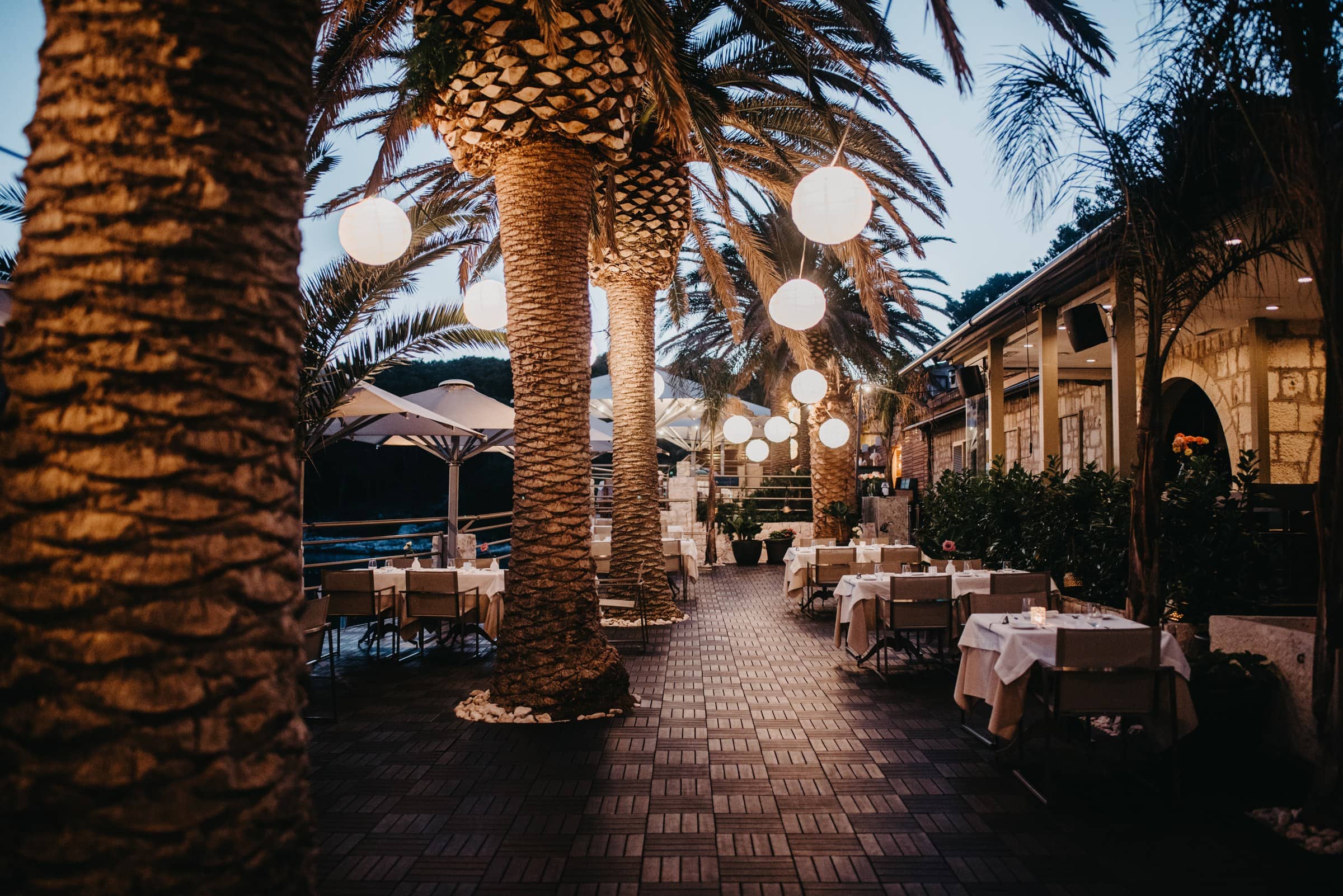The Zori restaurant terrace at night, lit above the bay of Vinogradišće