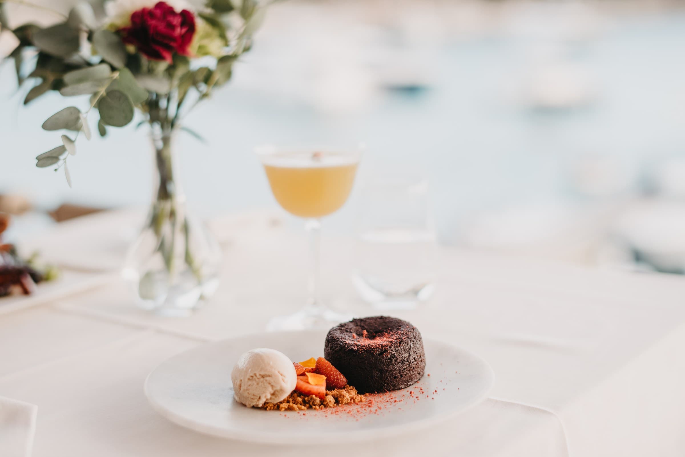 Dark chocolate dessert with maraska cherry and a cocktail at dusk, Zori Restaurant terrace, Palmižana