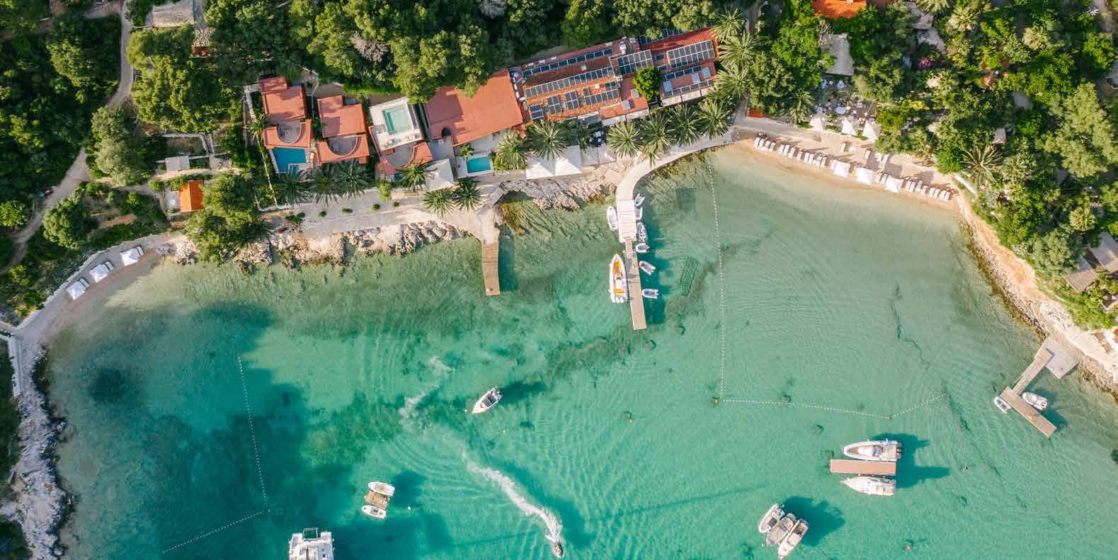 aerial view, cove, boats, coastal restaurant, turquoise water